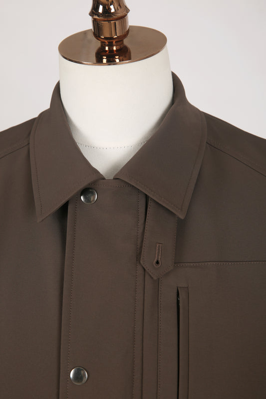 Brown coat on a mannequin with a white background