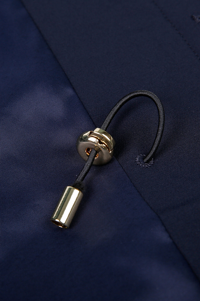 Close-up of a gold drawstring on a navy blue jacket
