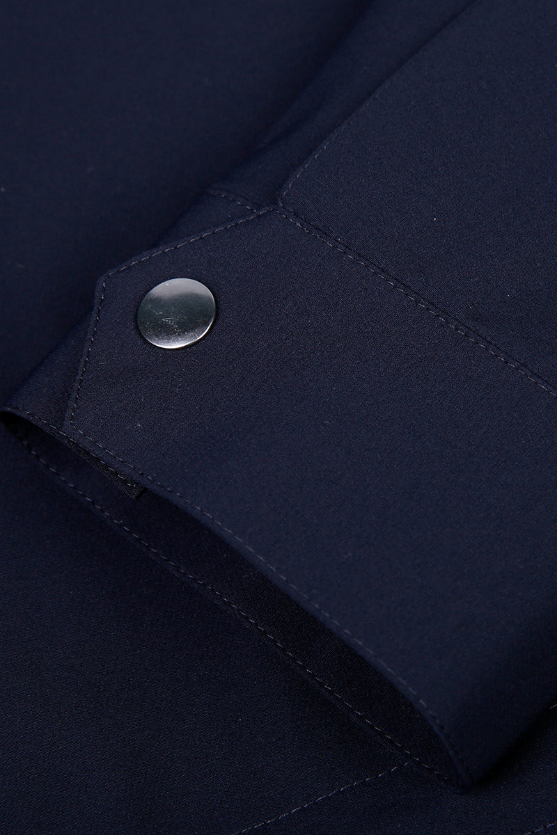 Close-up of a navy blue jacket sleeve with a button