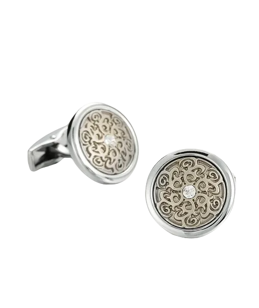 Silver cufflinks with intricate designs on a light gray background