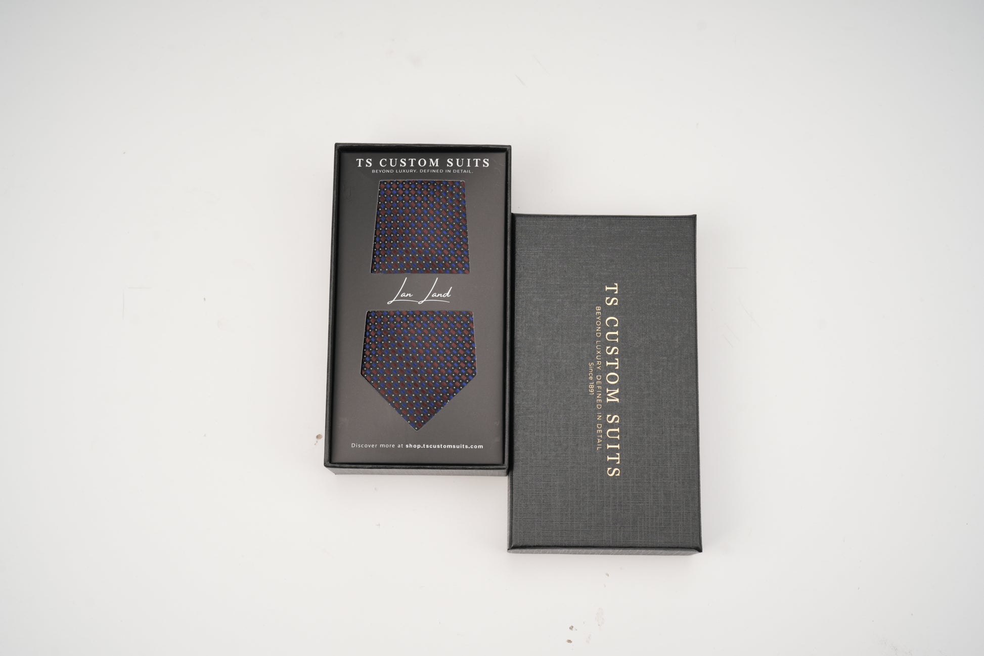 Two gray boxes with 'TC Custom Suits' branding on a white background