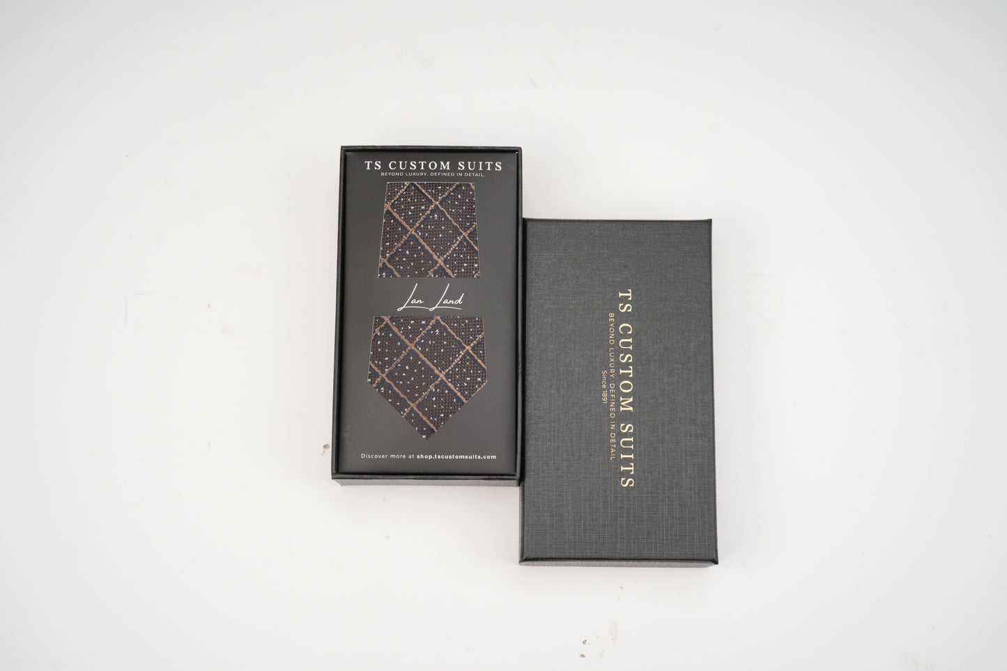 Two gray boxes with a patterned tie design and 'TS Custom Suits' branding on a white background.