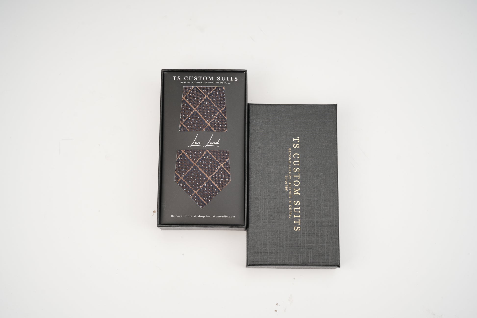 Two gray boxes with a patterned tie design and 'TS Custom Suits' branding on a white background.
