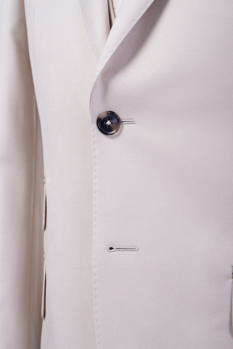 Cream wedding suit. Beach wedding suit. Single breasted cream wedding suit with peak lapels and a central vent. Real horn buttons. Suit for beach weddings. Destination wedding suit. Off-white suit. Summer wedding suit.