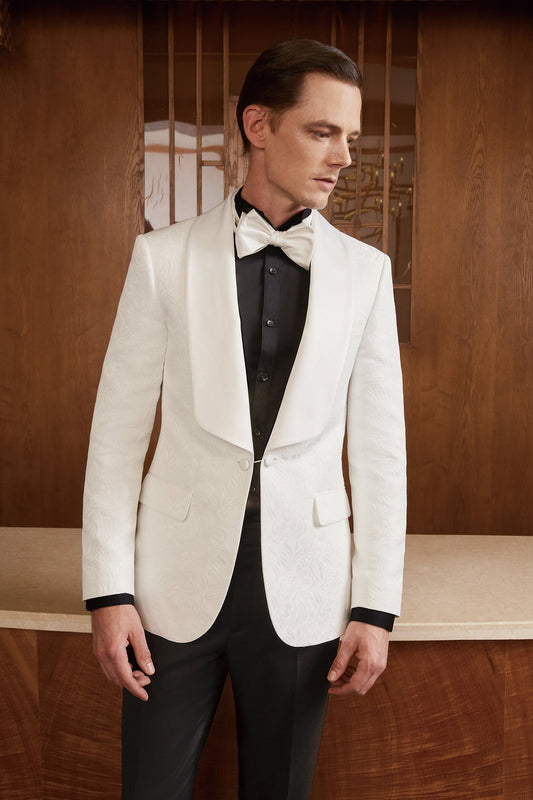 White shawl lapel embroidered tuxedo with black pants. White wedding tux. White shawl lapel tuxedo. Satin covered buttons and satin shawl lapel on this beautifully embroidered white wedding tuxedo. Perfect wedding tux for groom.