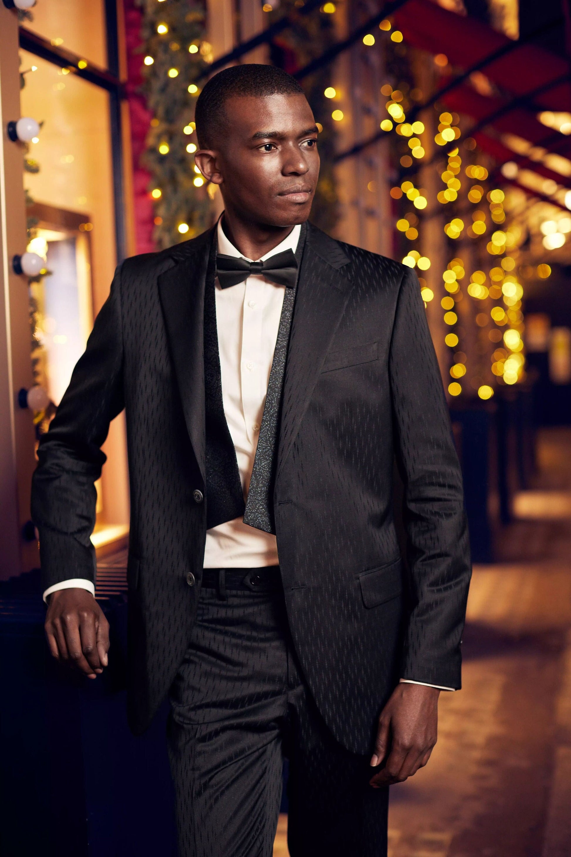 Black wedding suit with notch lapels and an accent vest. Unique design in the fabric. Black suit for groom. Black wedding suit. Groom black wedding suit traditional notch lapel.