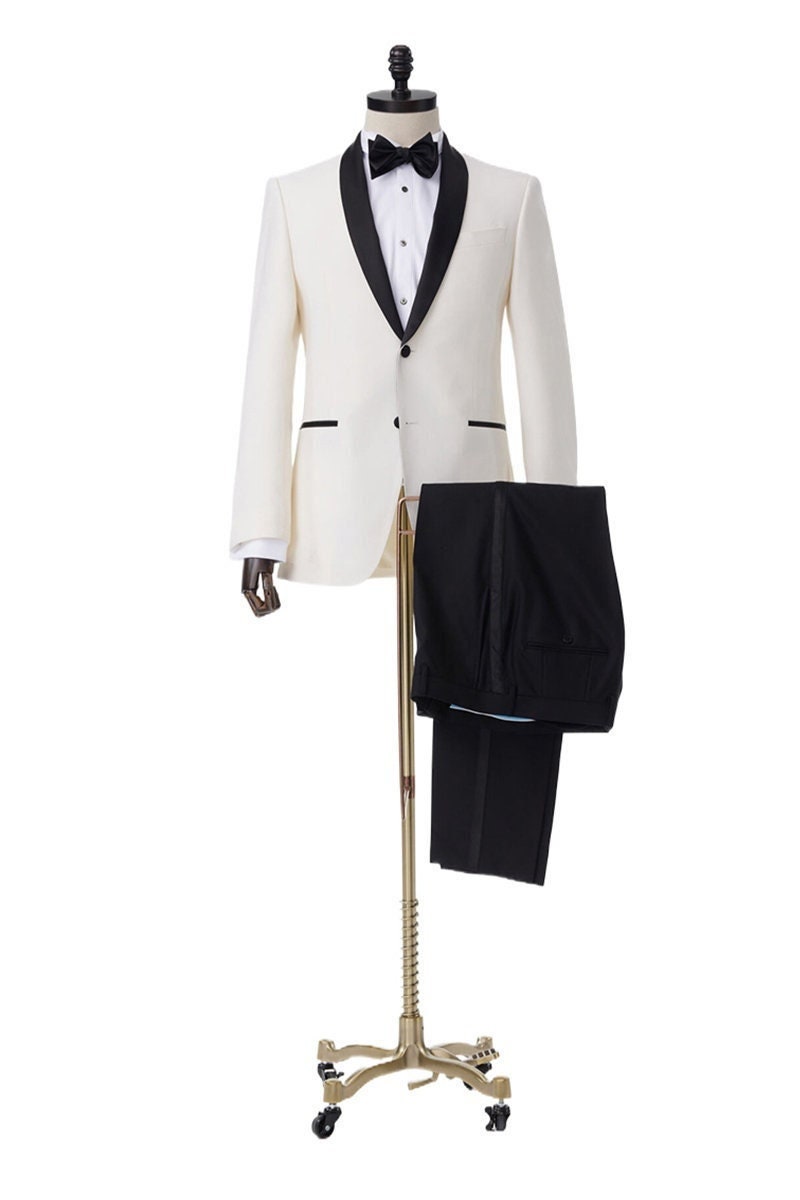 Ivory tuxedo with black shawl lapel. ivory wedding tuxedo. ivory off-white wedding tuxedo with black pants and a black satin accent stripe. Black satin lapel, satin covered buttons, black satin pocket accents on this ivory wedding tuxedo.
