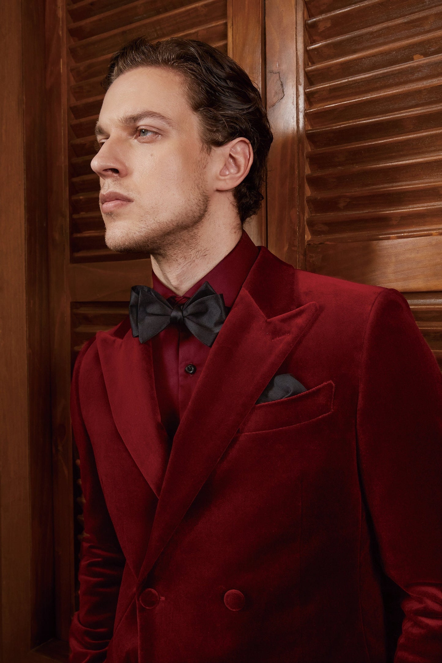 Red velvet tuxedo. Double breasted velvet tuxedo jacket with velvet covered buttons. Dark red maroon velvet tuxedo. Black pants with black satin accent stripe. Velvet wedding tuxedo. Velvet formal tuxedo.