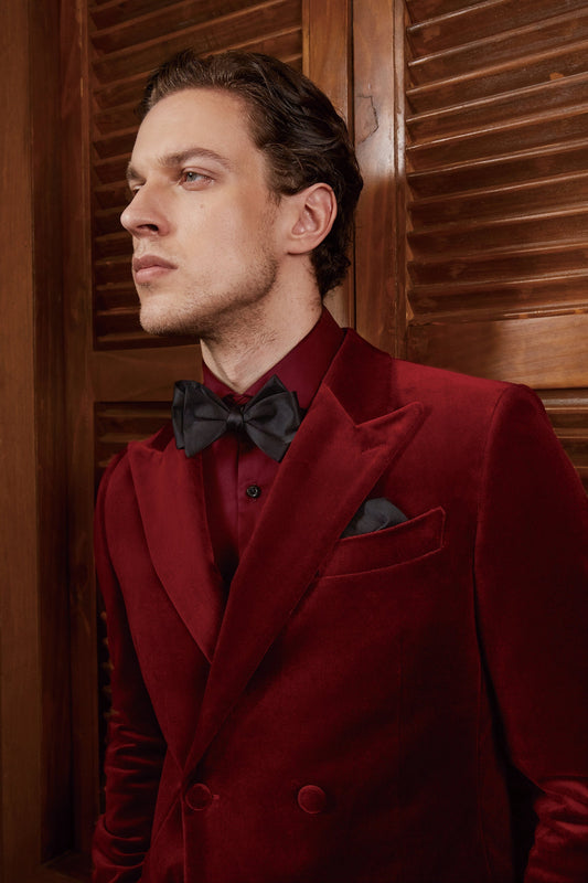Red velvet tuxedo. Double breasted velvet tuxedo jacket with velvet covered buttons. Dark red maroon velvet tuxedo. Black pants with black satin accent stripe. Velvet wedding tuxedo. Velvet formal tuxedo.