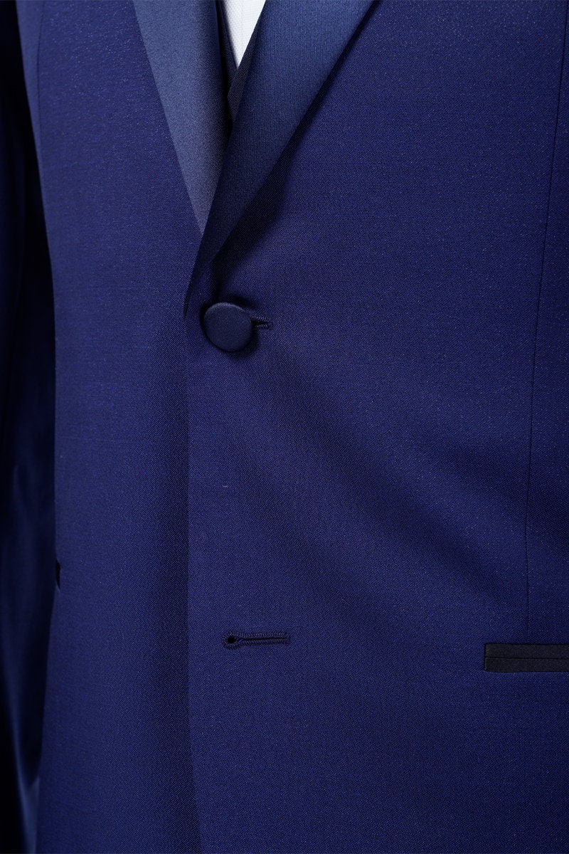Navy wedding tuxedo with blue satin peak lapel. Single breasted navy tux with blue satin accents. 3-piece navy wedding tuxedo. Custom navy tuxedo for wedding.