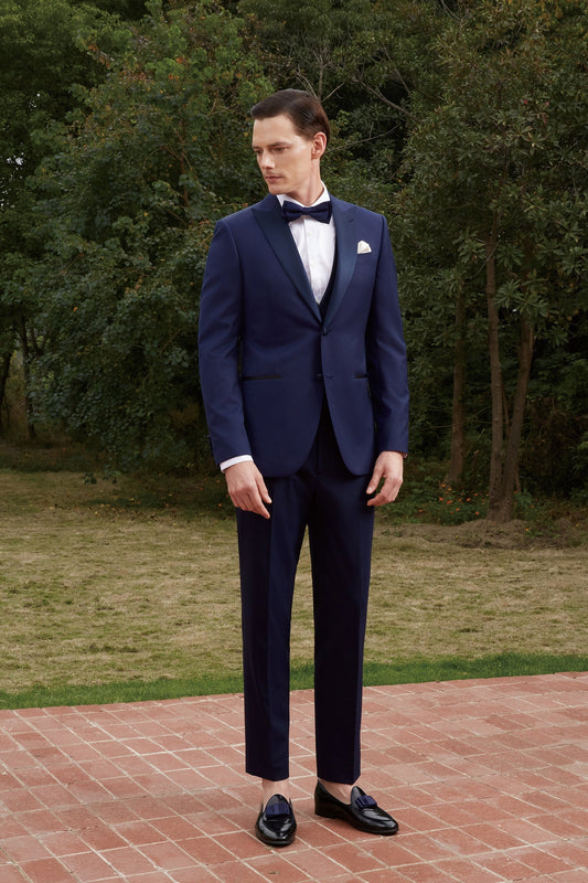 Navy wedding tuxedo with blue satin peak lapel. Single breasted navy tux with blue satin accents. 3-piece navy wedding tuxedo. Custom navy tuxedo for wedding.
