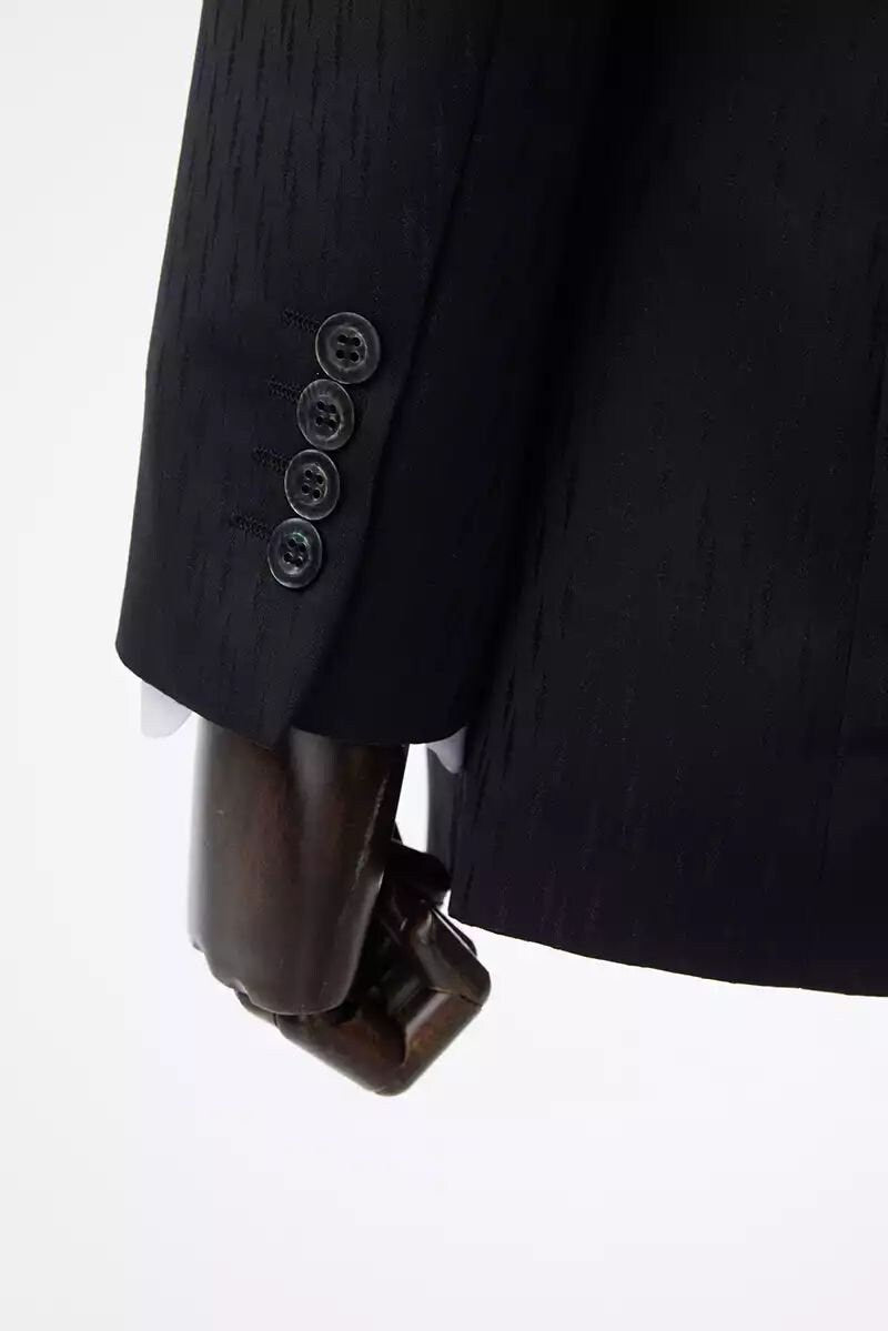 Black wedding suit with notch lapels and an accent vest. Unique design in the fabric. Black suit for groom. Black wedding suit. Groom black wedding suit traditional notch lapel.