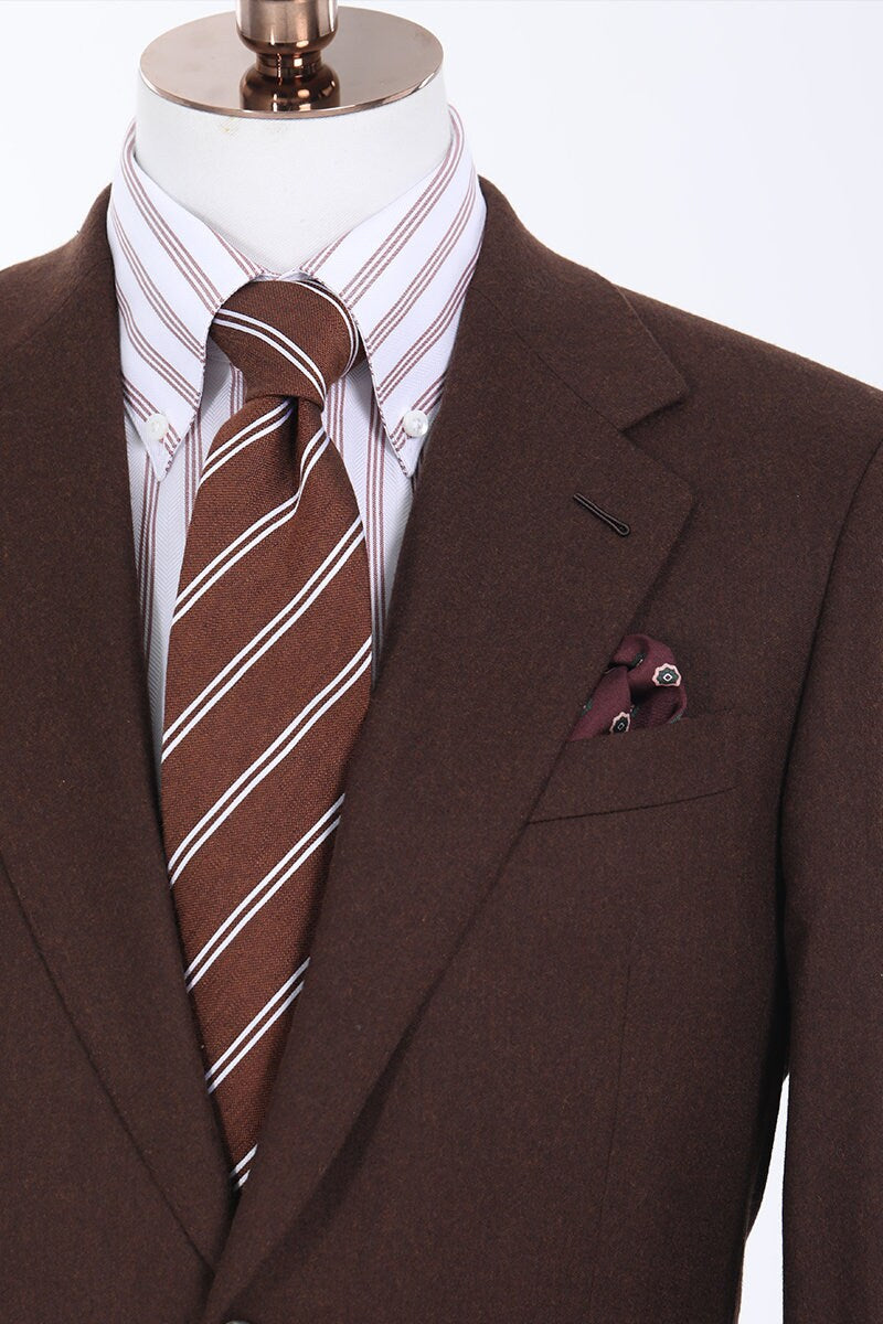 Brown 2-piece suit with single breast and notch lapel. Pants have a 2-button waistband, watch pocket, and a buckle adjuster on the hips. Mens brown suit. Brown wedding suit. Custom wedding suit. Chocolate brown suit.