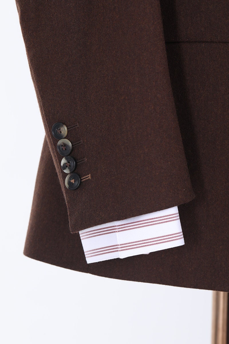 Brown 2-piece suit with single breast and notch lapel. Pants have a 2-button waistband, watch pocket, and a buckle adjuster on the hips. Mens brown suit. Brown wedding suit. Custom wedding suit. Chocolate brown suit.