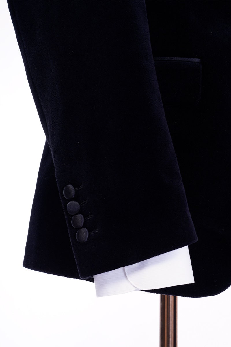 Black velvet wedding tuxedo. Black velvet tux with satin peak lapel and black trousers. Satin covered buttons and satin accents on the pockets on this black velvet formal wedding tuxedo. black velvet tux. formal wedding tuxedo. black tux for groom.