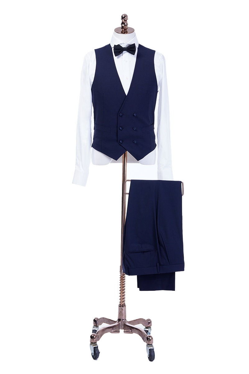 Navy wedding tuxedo with blue satin peak lapel. Single breasted navy tux with blue satin accents. 3-piece navy wedding tuxedo. Custom navy tuxedo for wedding.