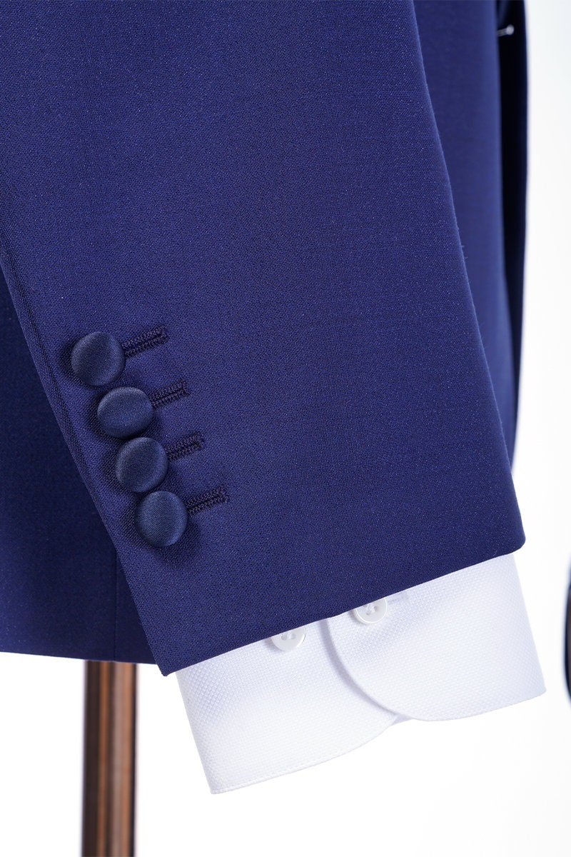 Navy wedding tuxedo with blue satin peak lapel. Single breasted navy tux with blue satin accents. 3-piece navy wedding tuxedo. Custom navy tuxedo for wedding.