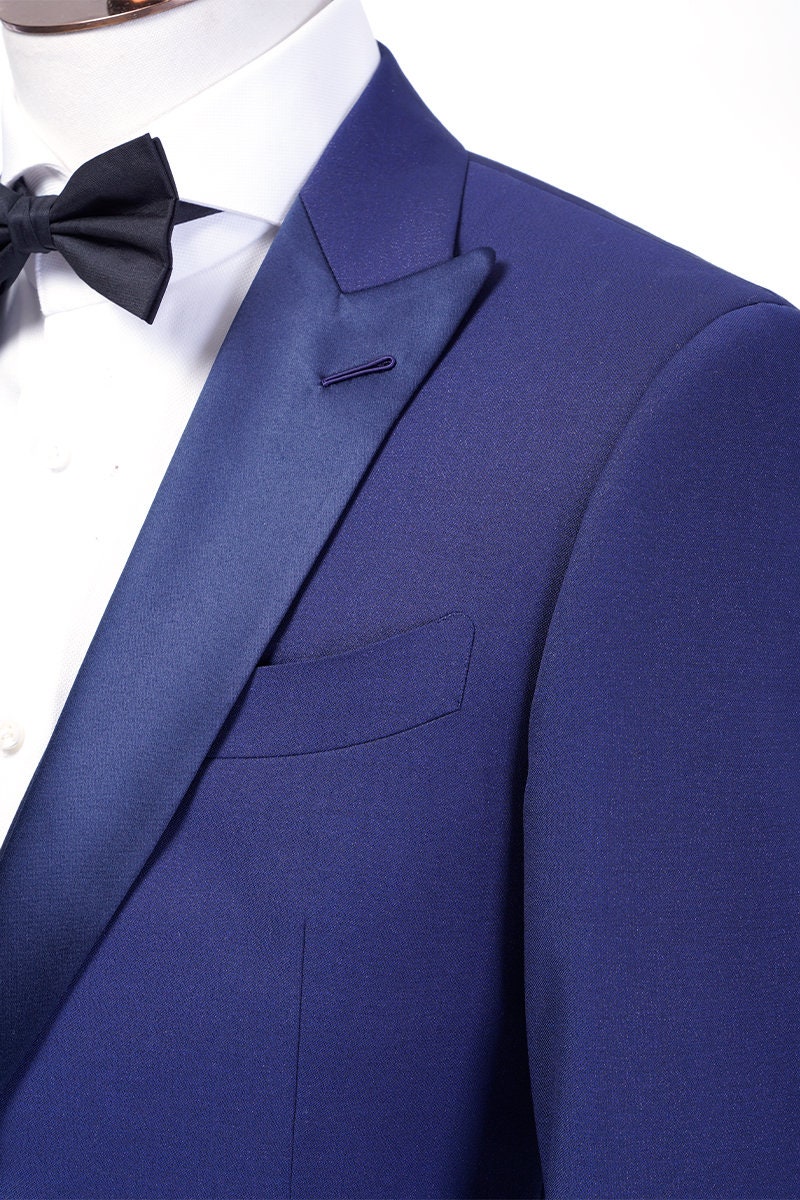 Navy wedding tuxedo with blue satin peak lapel. Single breasted navy tux with blue satin accents. 3-piece navy wedding tuxedo. Custom navy tuxedo for wedding.