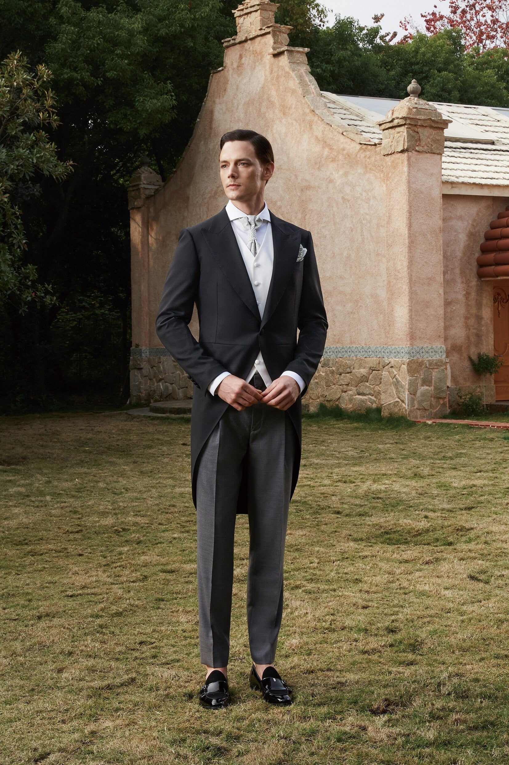 Black formal tail tuxedo. Black tuxedo with peak lapel. Comes with white vest. Fabric covered buttons and grey pants. Elegant and timeless tuxedo. Black tail tux. Wedding tuxedo. Black wool wedding tux with tail. Morning Coat Tuxedo.