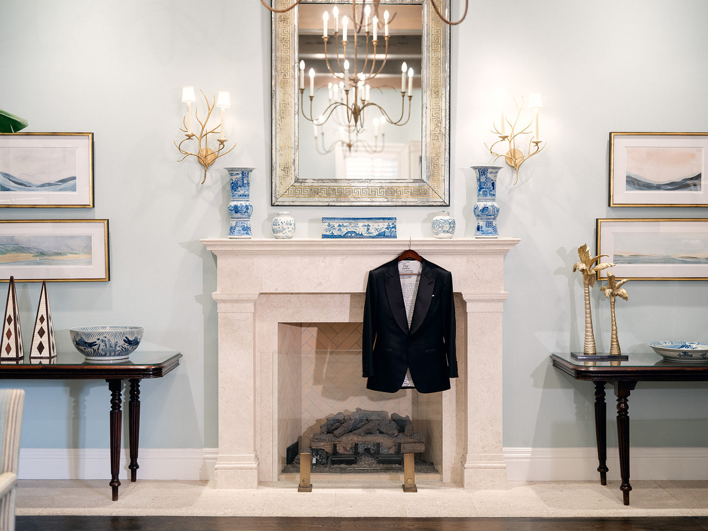 Living room with a fireplace, mirror, and decorative items.