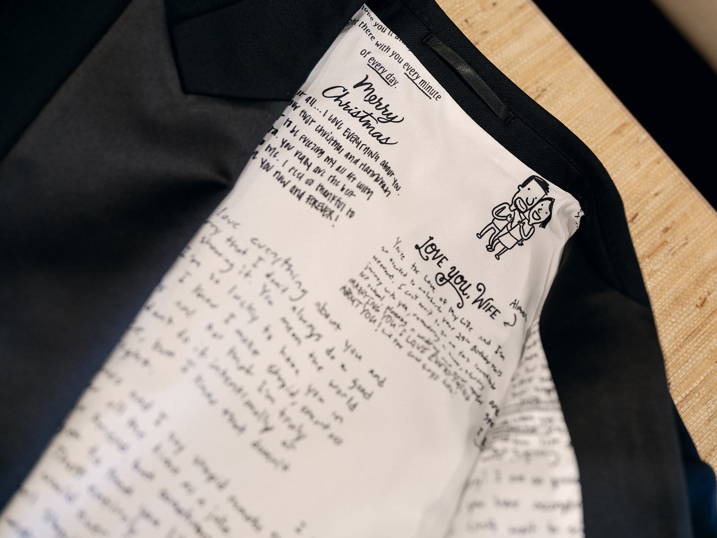 Personalized letter with a drawing of a child and 'Merry Christmas' on a black garment.