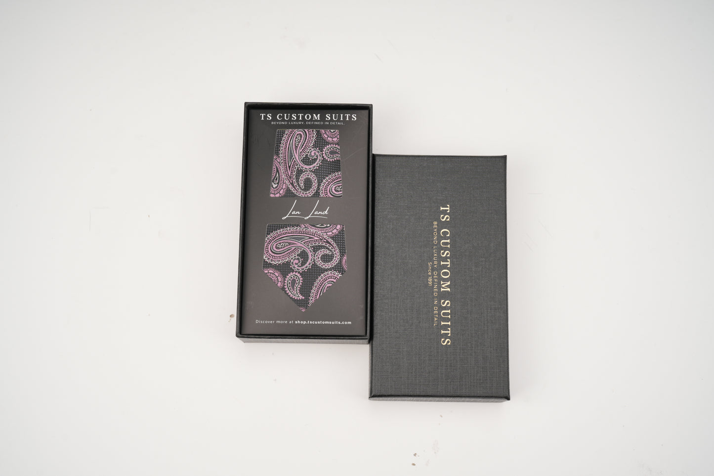 Two gray boxes with paisley design and 'TS Custom Suits' branding on a white background