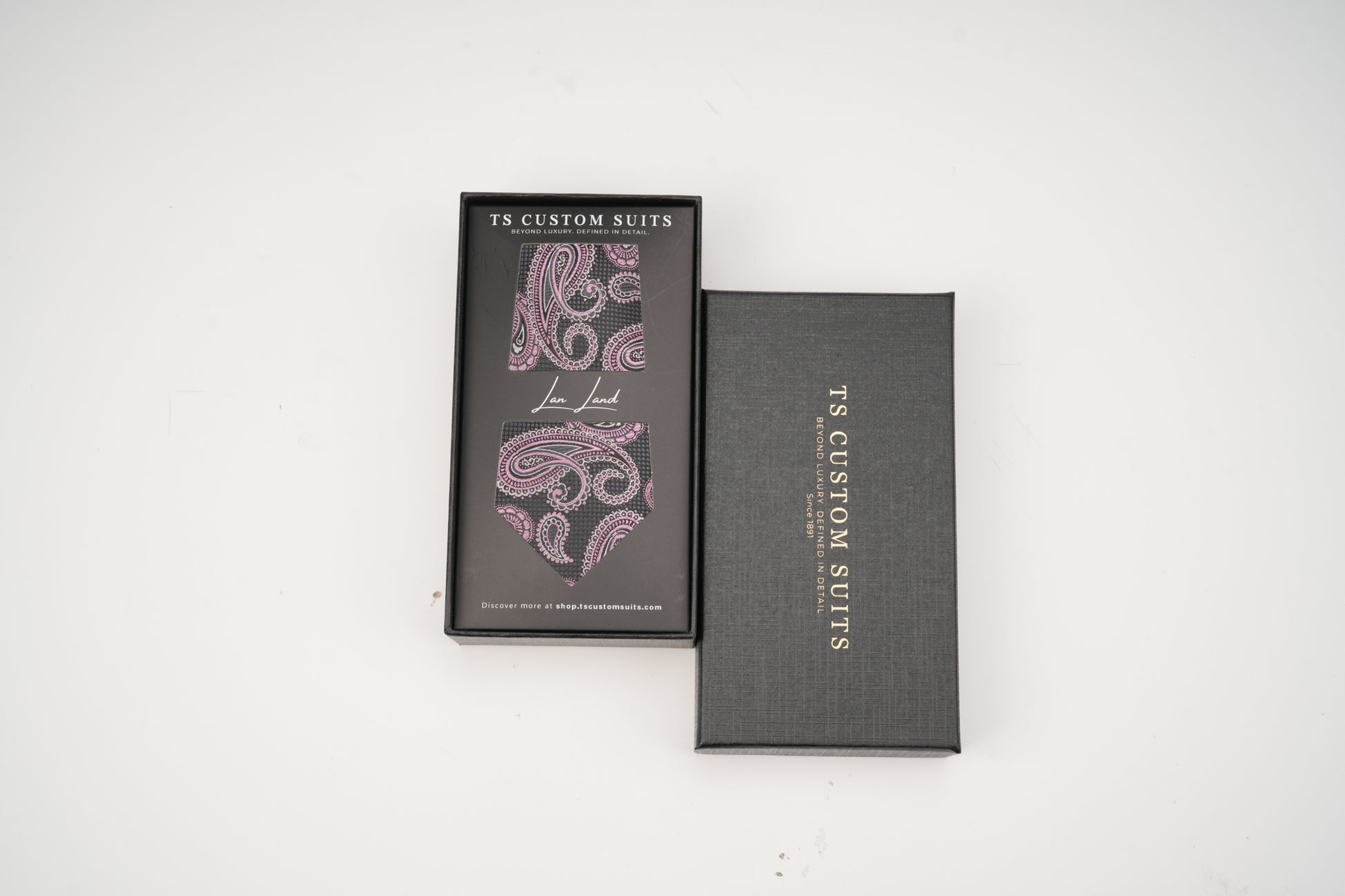 Two gray boxes with paisley design and 'TS Custom Suits' branding on a white background