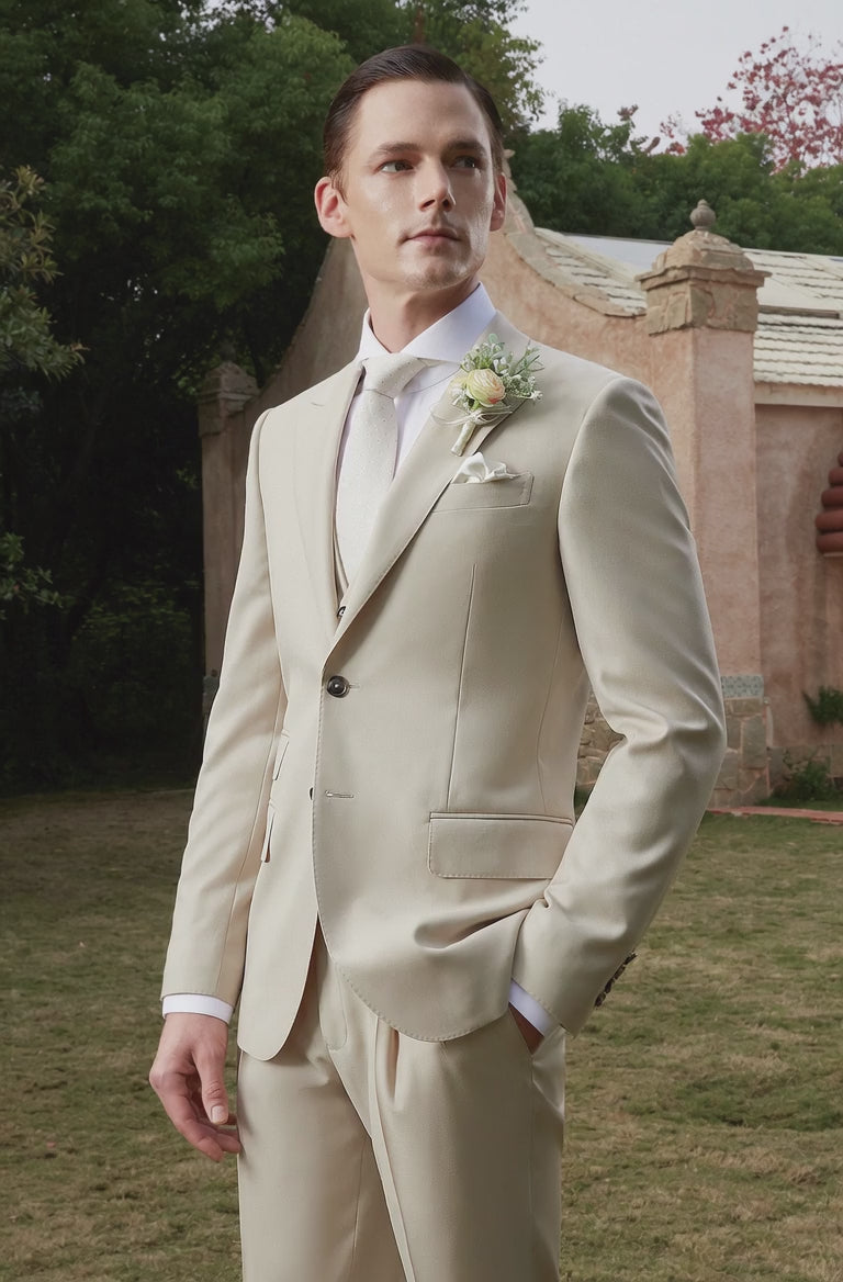 groom wearing a tan wedding suit outside
